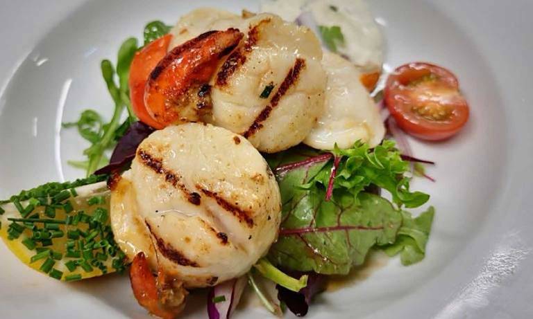 The Holly Tree Hotel & Swimming Pool has a fantastic restaurant overlooking Loch Linnhe were you can enjoy delicious food & drink like these hand-dived Scallops.